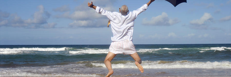 Happy businessman on a beautiful tropical beach