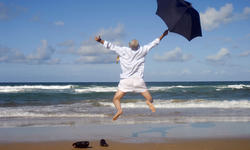 Happy businessman on a beautiful tropical beach